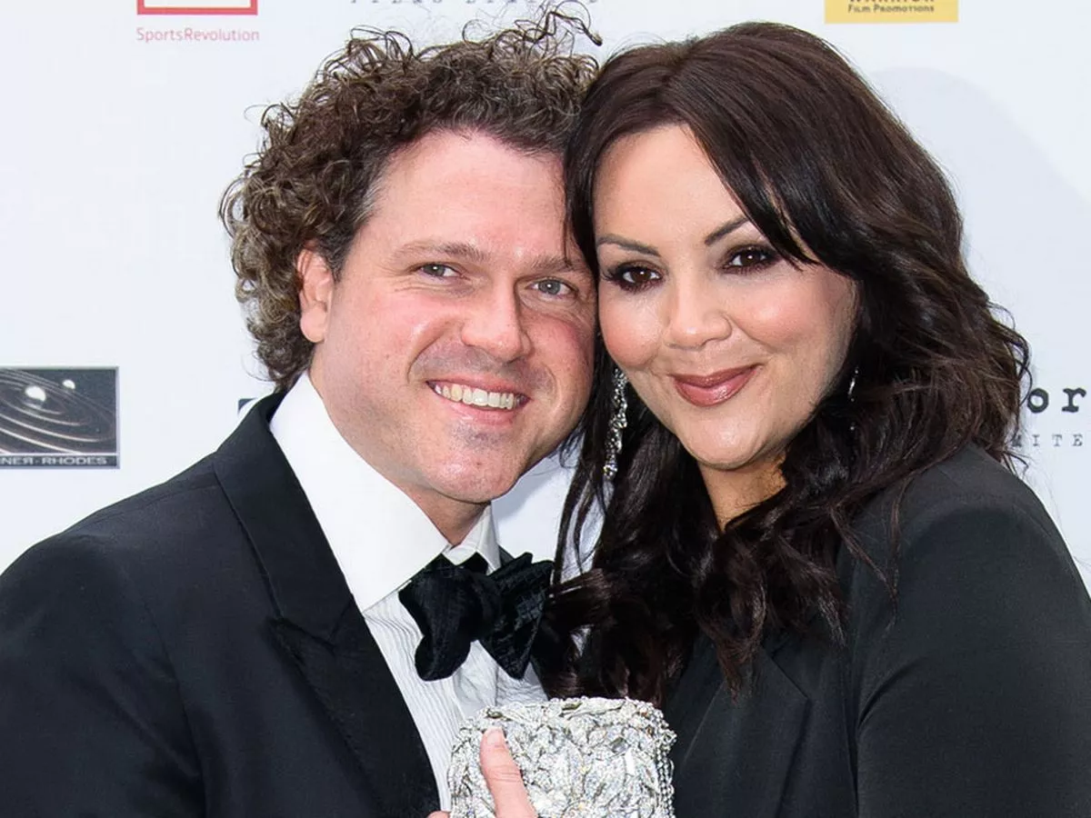 Martine McCutcheon and Jack McManus posing together on the red carpet, dressed elegantly for a formal event.