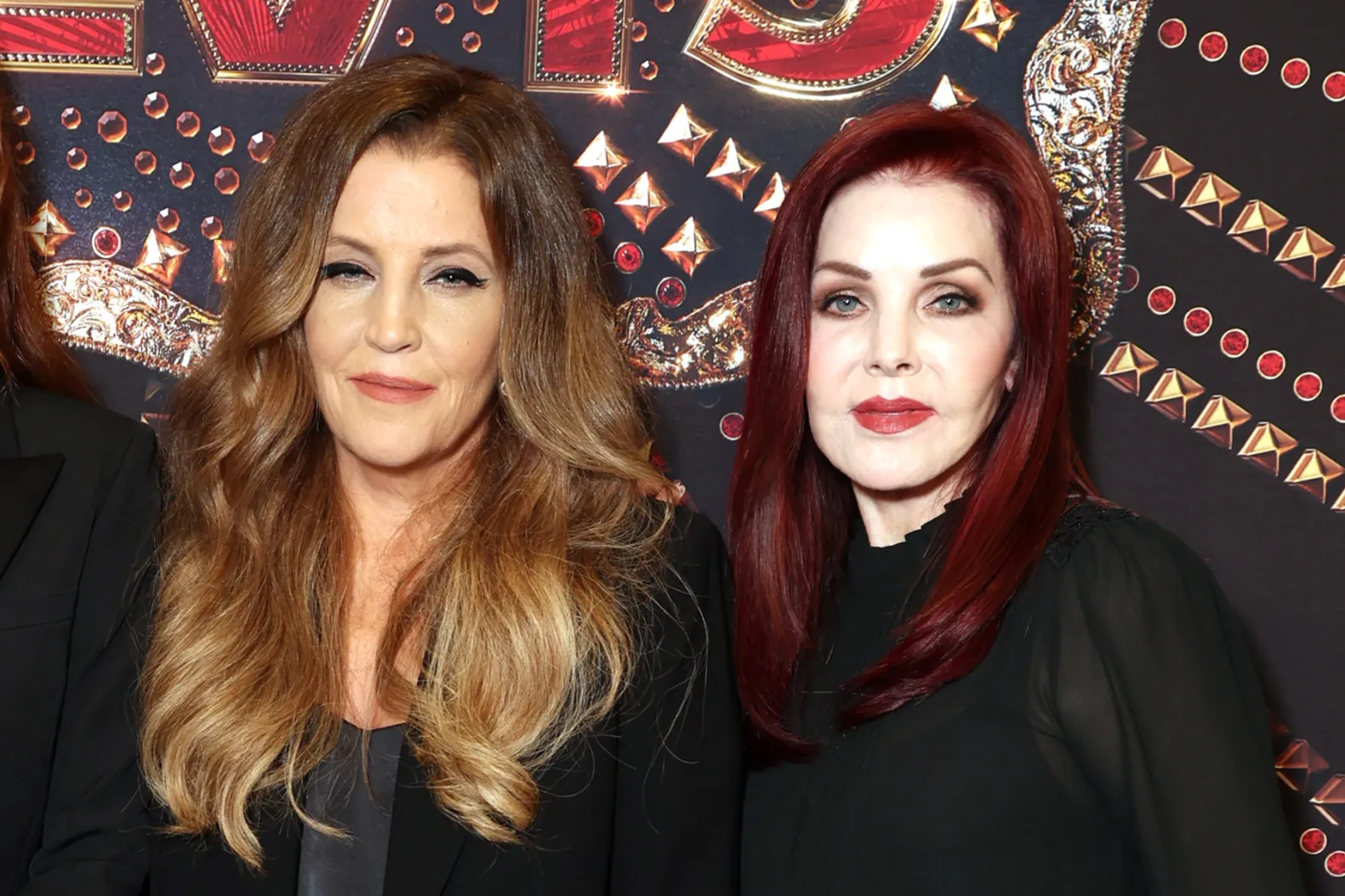 Priscilla Presley and Lisa Marie Presley posing together on the red carpet, smiling and dressed in elegant outfits.