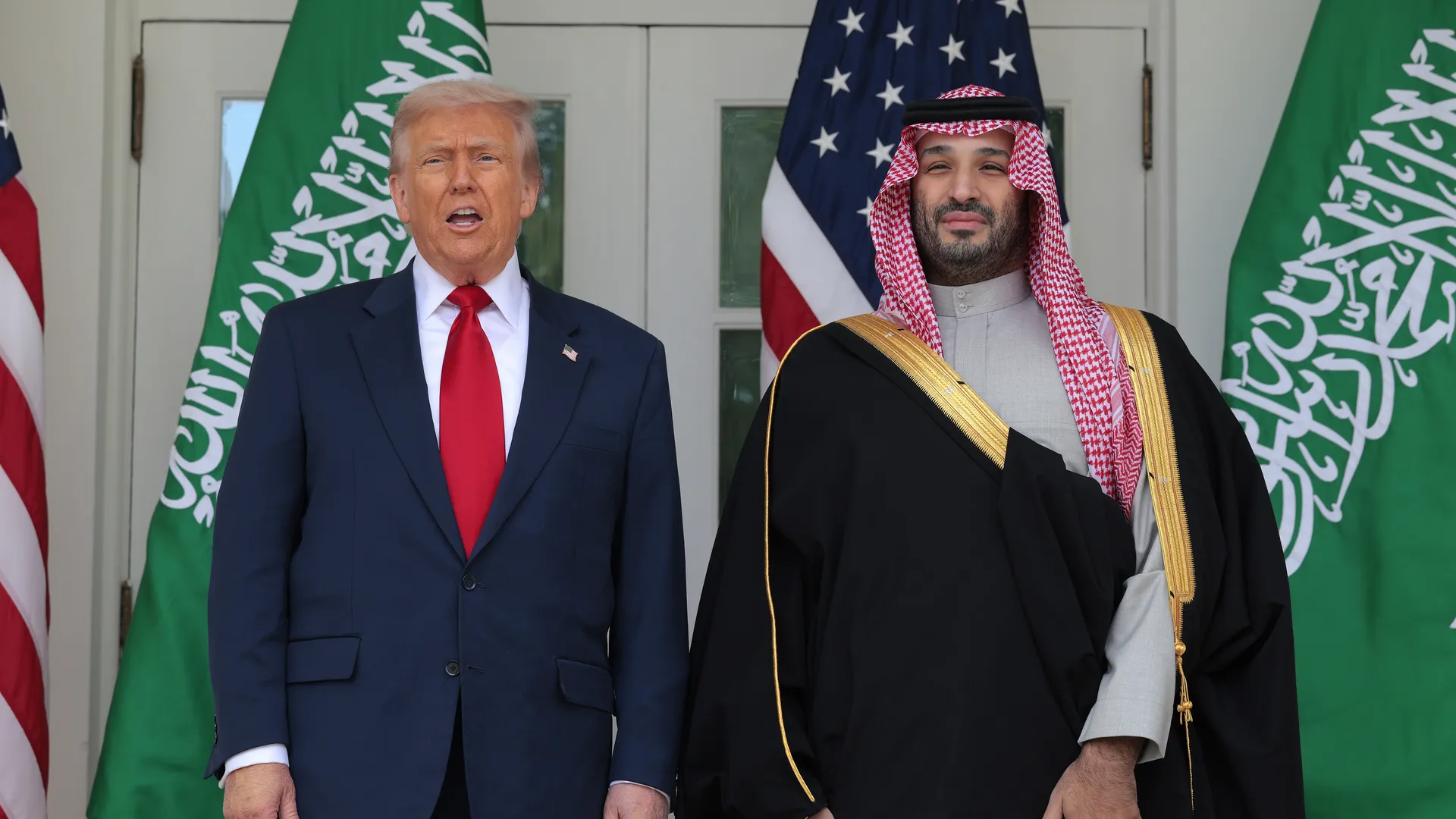 Donald Trump and Saudi Crown Prince Mohammed bin Salman standing outside the White House, posing for photos during a meeting amid ongoing Trump Organization business dealings with Saudi investors.