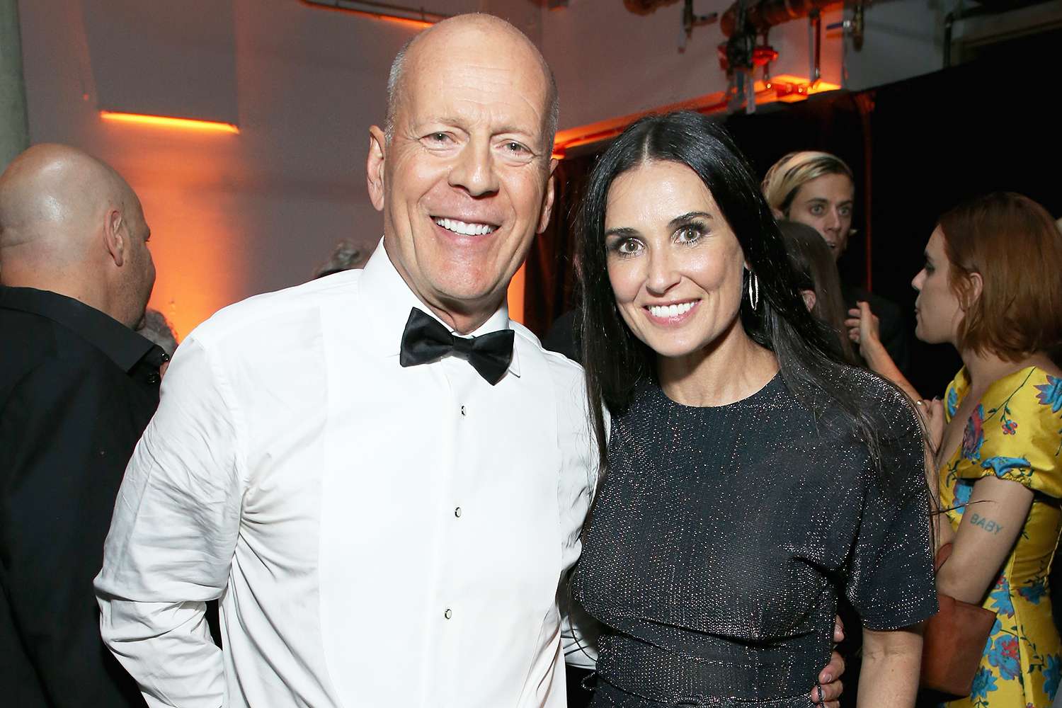 Demi Moore and Bruce Willis smiling together at a red carpet event before his dementia diagnosis.