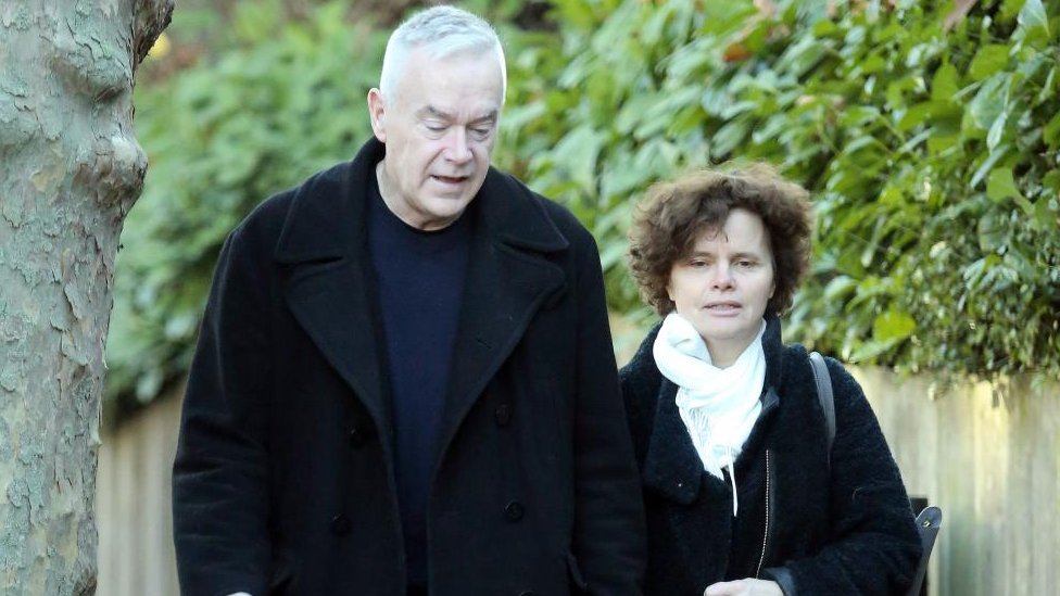 Huw Edwards and his wife Vicky Flind together at a public event, appearing serious.