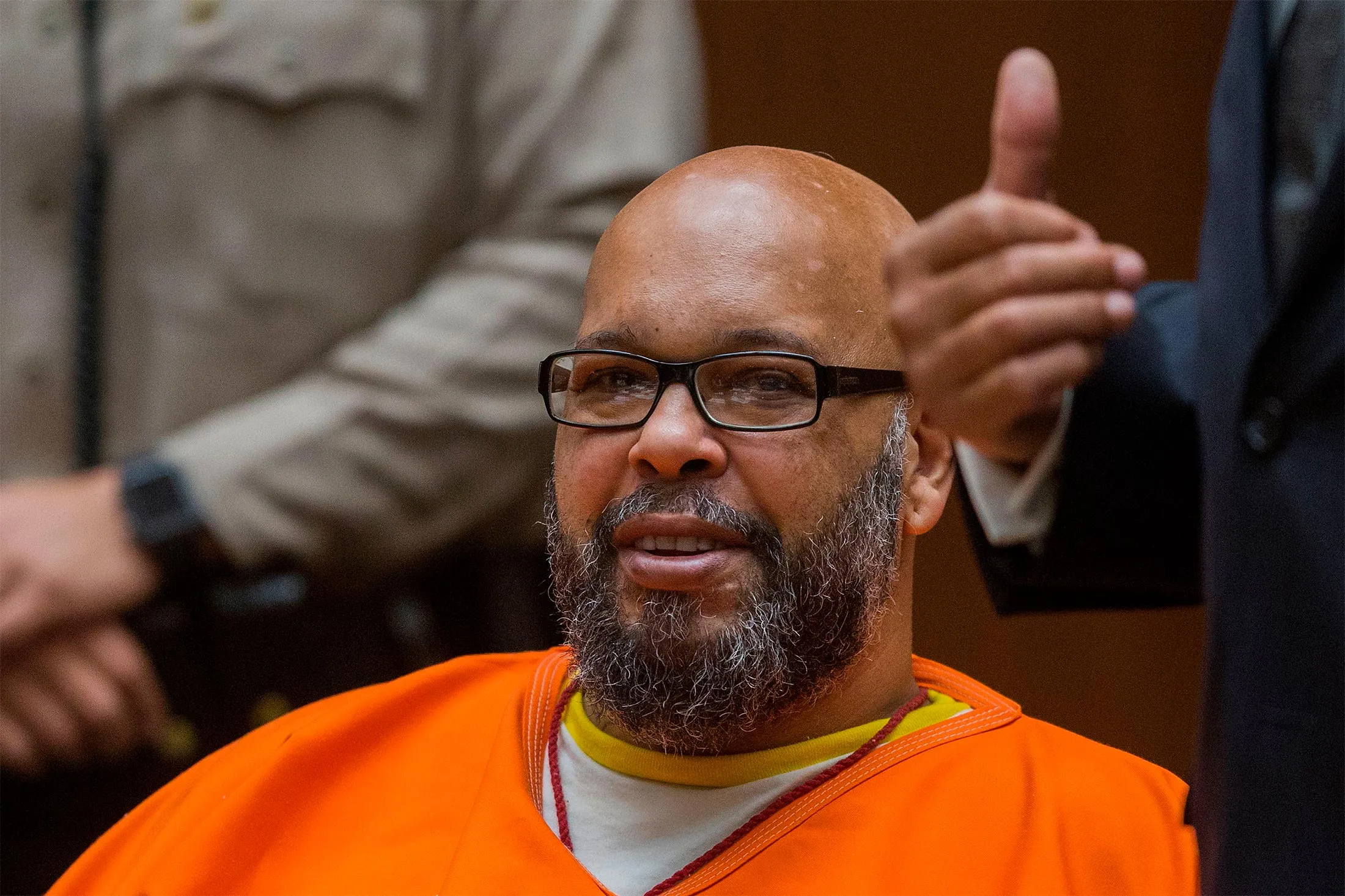 Suge Knight wearing an orange prison jumpsuit appearing in court.