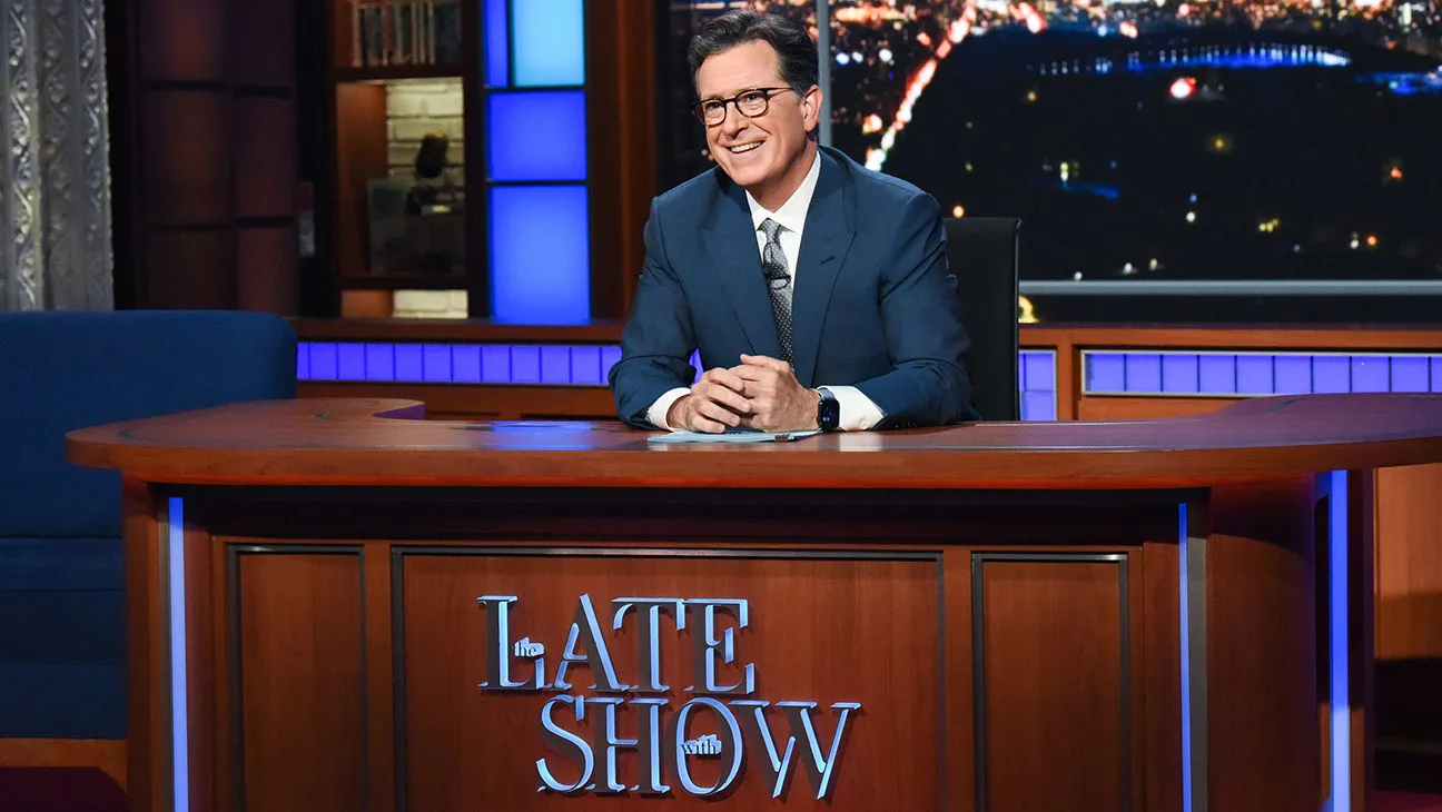 Stephen Colbert sitting at the the late show desk.