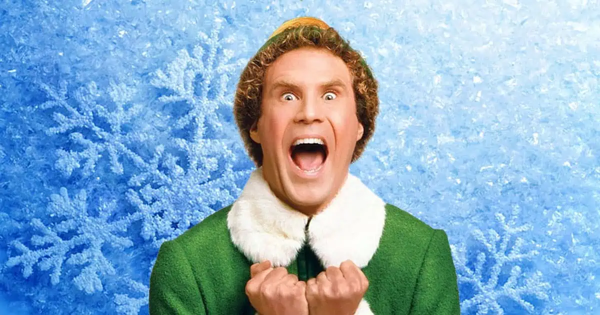 Buddy the Elf from Elf jumping and cheering with excitement, wearing his green and yellow elf costume.