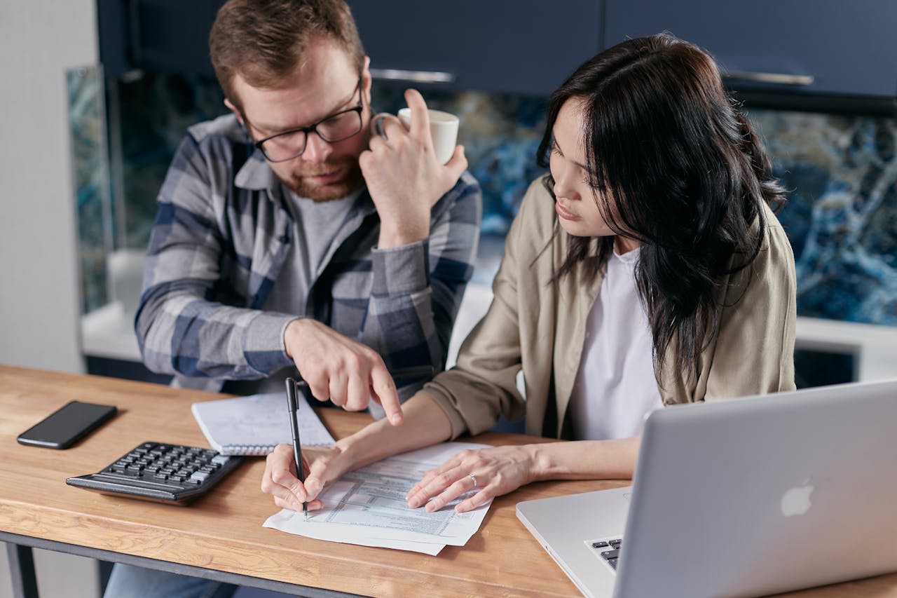 man and woman looking at their finances