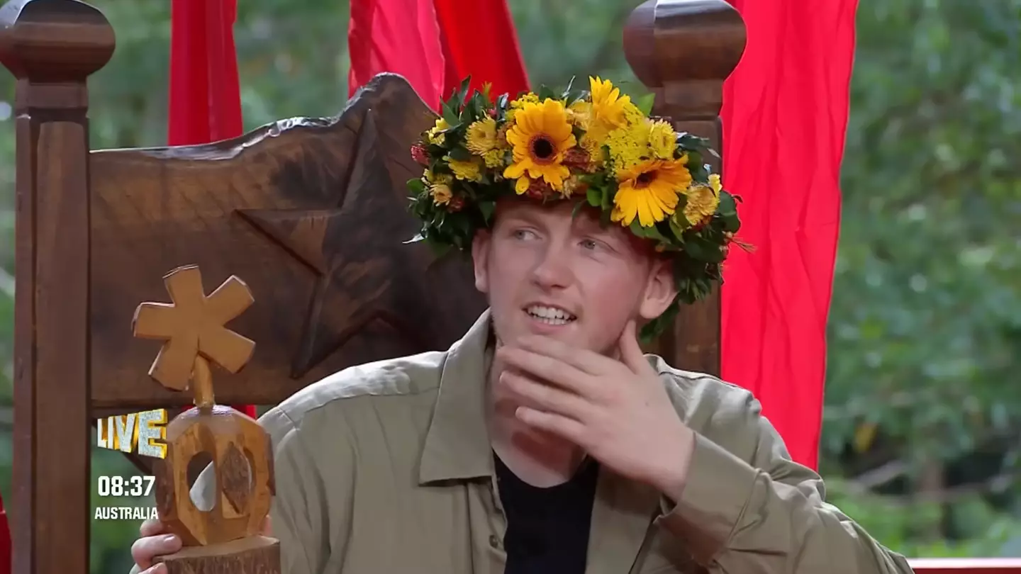Angry Ginge sits down for his post-win interview, still emotional and smiling, as studio lights and the jungle backdrop frame the moment he reflects on becoming King of the Jungle 2025.