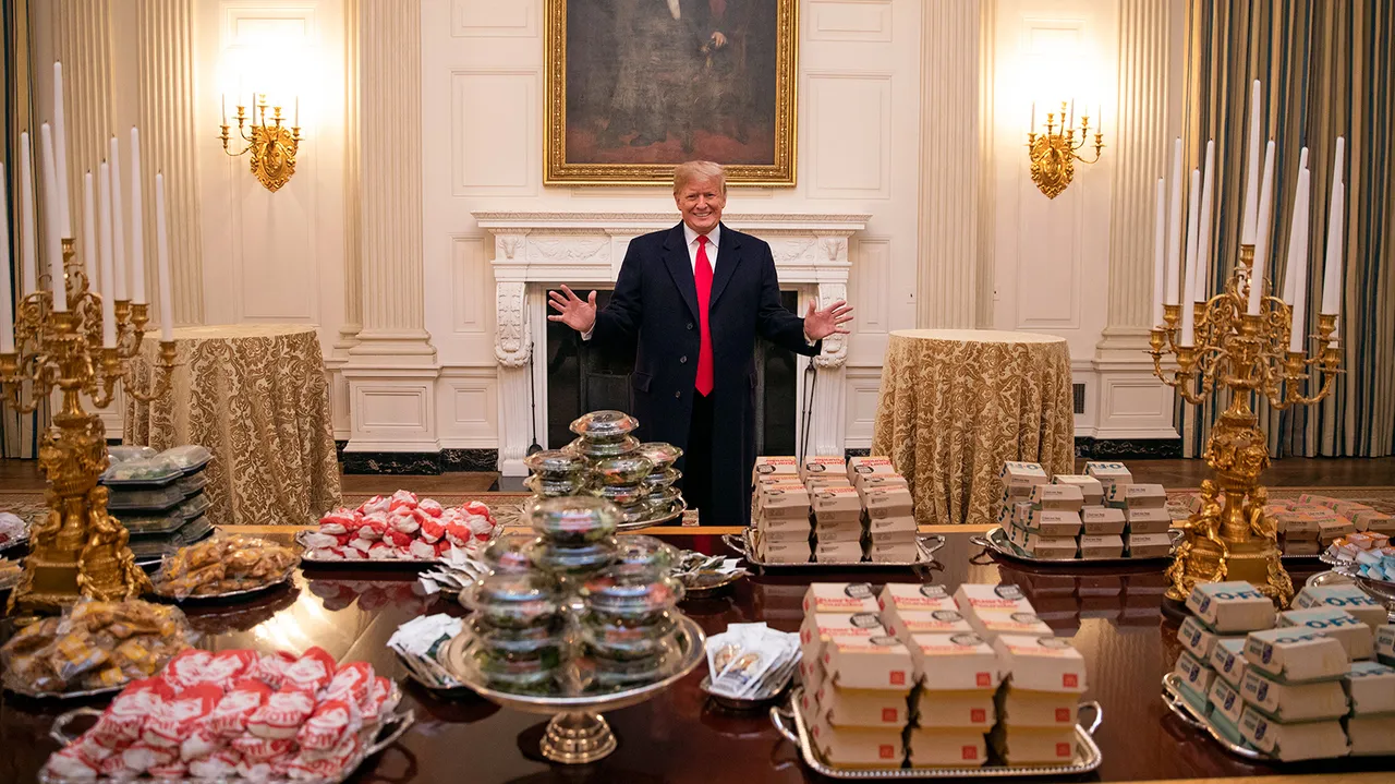 Donald Trump stands inside the White House beside a table covered with McDonald’s fast food during a widely shared photo highlighting his love of the chain.