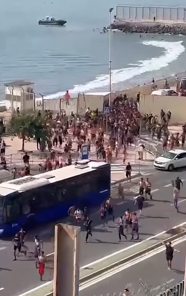 Hundreds of migrants have entered the Spanish north African exclave of Ceuta by sea in recent days, officials said Thursday, with local television images showing them swimming around the frontier and running into the town