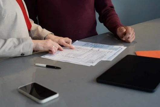 A person reviewing insurance documents at a desk