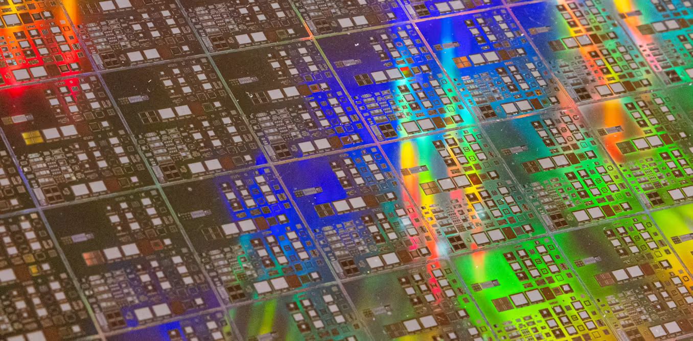 Rows of AI memory chips beside glowing server racks and rising financial charts