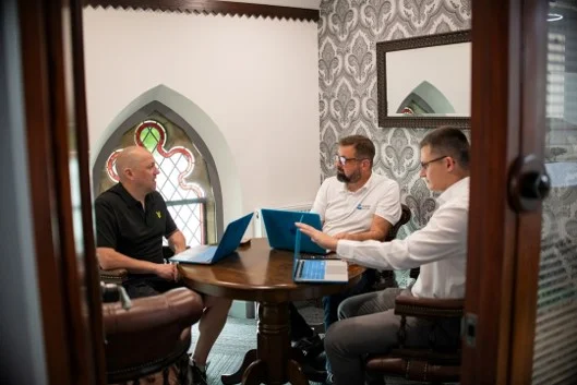A business team reviewing documents around a boardroom table