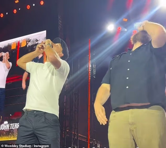 John Terry was booed as he chugged a pint of beer on stage with Luke Combs during his London gig on Friday night