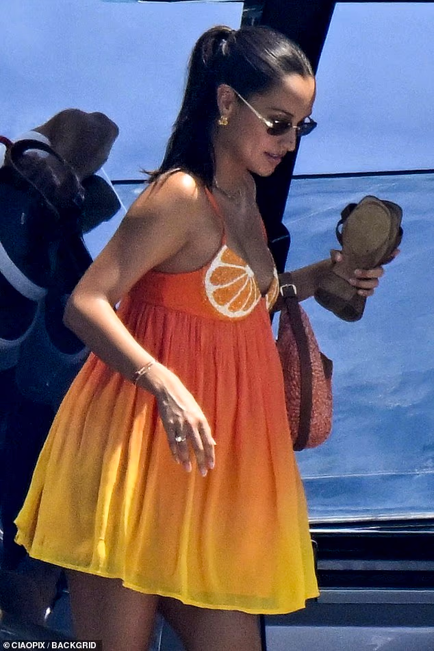 Charles Leclerc's wife Alexandra showed off her 'baby bump' as she joined him and their miniature dachshund Leo on board a £15million yacht in Sardinia on Wednesday