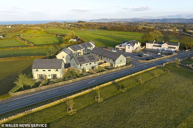 The construction firm behind the 16-home estate in Anglesey, north Wales, could appeal to the Welsh government after its application to overturn the planning rule was rejected by the local council