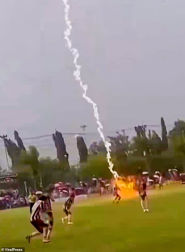 Footage captured a lightning bolt strike through heavy rain and near players on the field, which was followed by a loud bang
