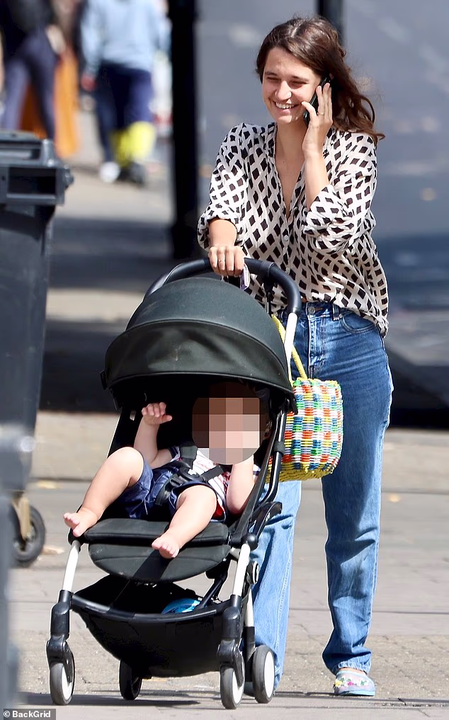 Michael Hutchence's daughter looks as happy as ever as she celebrates a year of motherhood. On Wednesday, Tiger Lily, 30, was beaming as she went for a stroll with her baby in the London sunshine